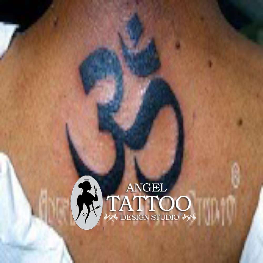 Om symbol tattooed on the wrist.