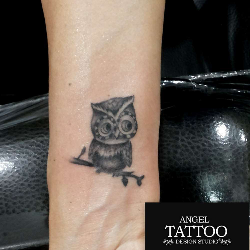 Minimalistic style owl tattoo located on the ankle.